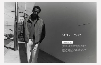 Black and white portrait of a model walking on a city sidewalk past a blank wall for the Zara Daily 24/7 campaign.