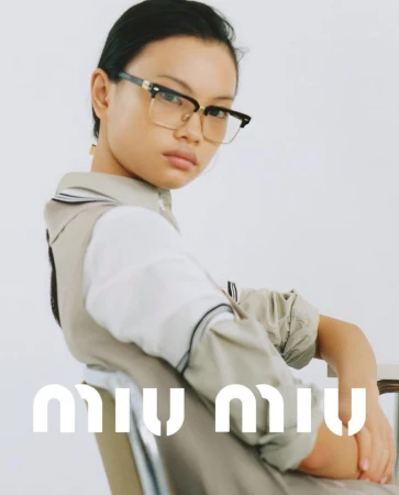 Model Yue Gu wearing eyeglasses and beige layered top for Miu Miu May/June 2024 lookbook against a plain white background