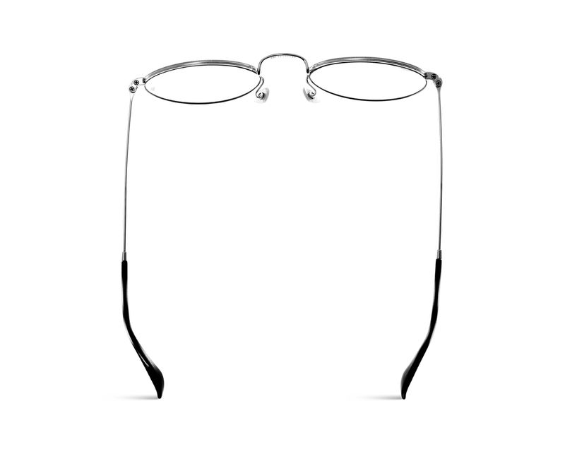 Close-up product shot: clear-lensed eyeglasses with thin silver metal frames and black earpieces set against a plain white backdrop.