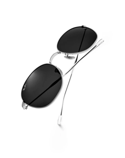 Studio shot of Ray-Ban sunglasses featuring black lenses and silver metal frames, set against a stark white backdrop.