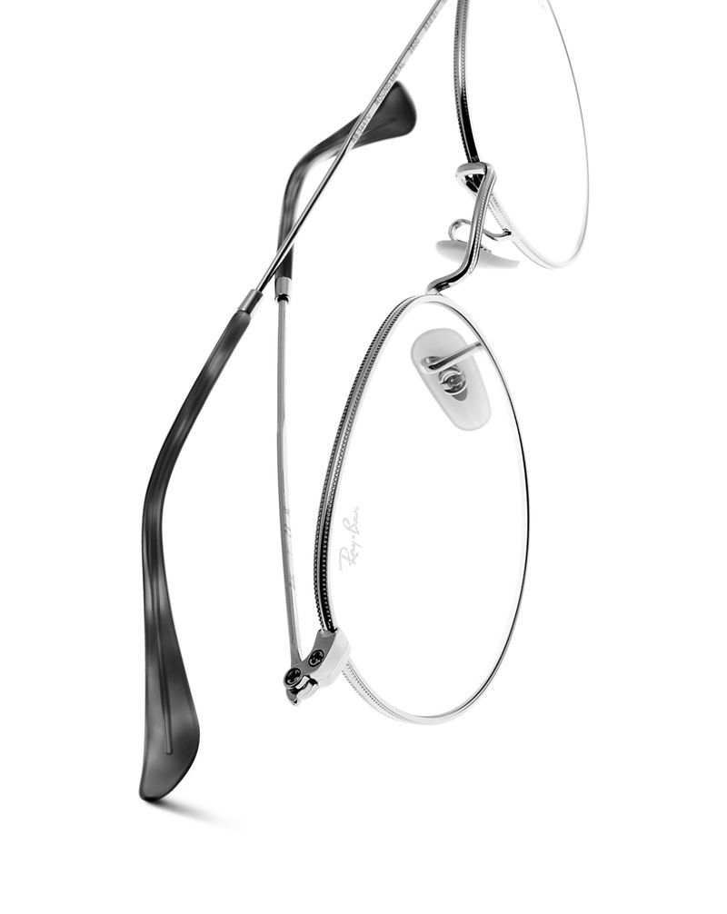 Ray-Ban glasses with silver metal frames and clear lenses on a white background, showcasing a modern and minimalist aesthetic.