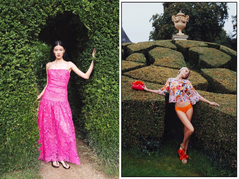 Two fashion models pose outdoors in green garden spaces; one wears a pink dress, the other a floral top and orange bottoms.