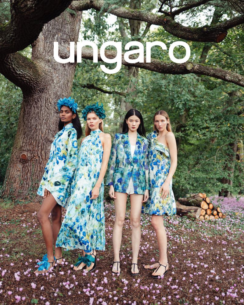 Four women model Ungaro floral apparel, standing in an outdoor setting with trees and purple groundcover, beneath the 'Ungaro' logo.