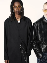 Two models posing against a white background, featuring a black button-down shirt and a black leather jacket.