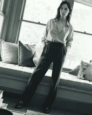 Model standing in a button-down shirt and trousers inside a room near large windows for J. Crew Fall 24 Men's Lookbook.