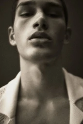 Close-up portrait of model Luka Tesic looking downward in a low angle shot by photographer Thomas Cooksey for H and M