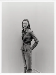 Model wearing a denim shirt and jeans posing against a plain grey wall for Mango denim campaign