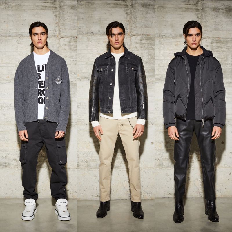 Three adult men stand against a concrete wall, showcasing fashion. The men wear various jackets, t-shirts, pants, and boots. 