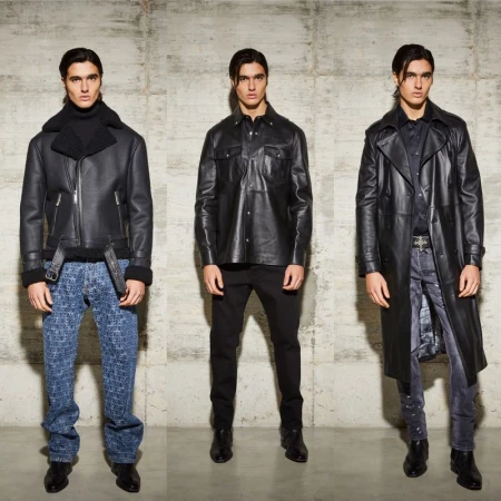 Three adult males present different fashion outfits against a neutral concrete backdrop in a studio shot, displaying leather jackets and coats.