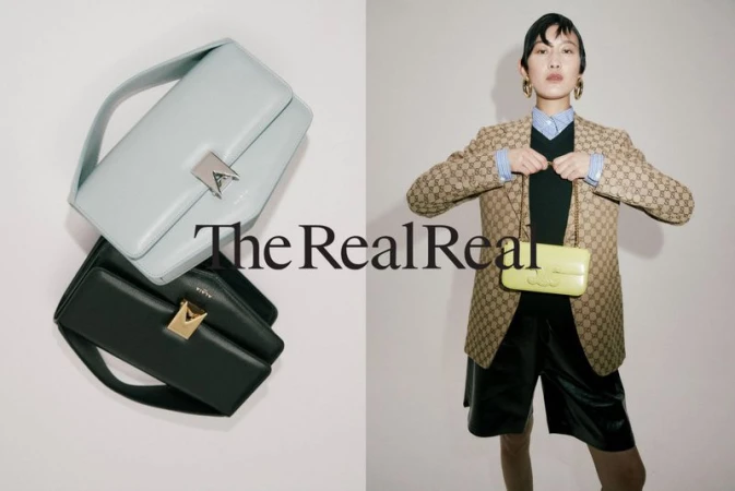 Model wearing monogram blazer and black shorts holding yellow handbag next to stacked luxury handbags on white background