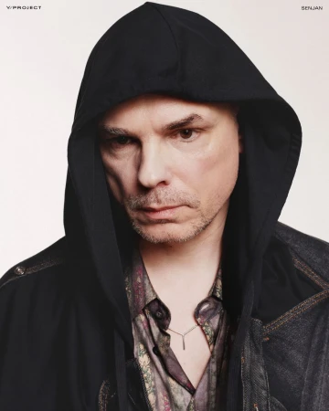 Man wearing a black hoodie and patterned shirt against a plain white background for Y/Project lookbook