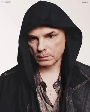 Man wearing a black hoodie and patterned shirt against a plain white background for Y/Project lookbook