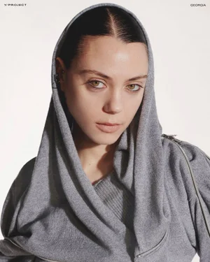 Portrait of a woman wearing a grey hooded top against a plain white background for Y/Project Fall/Winter 24 lookbook.