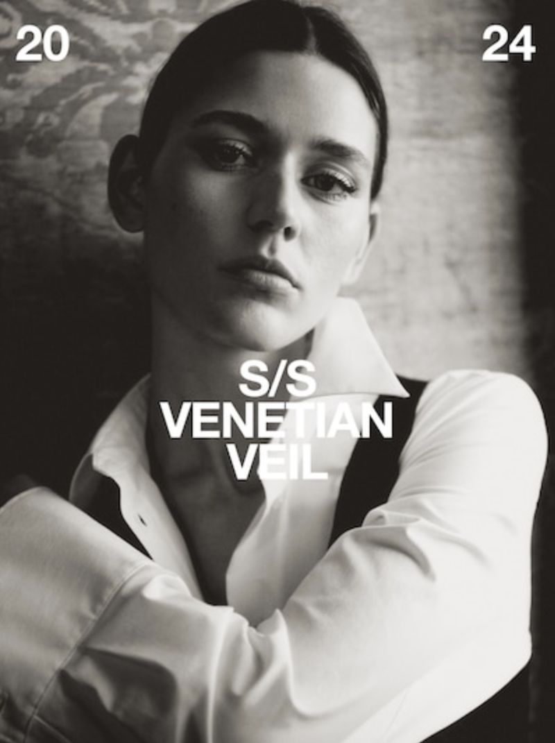 Black and white portrait of a woman in a collared shirt, styled for a magazine cover with text overlay and a slightly blurred background.