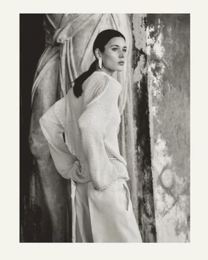 Monochrome fashion portrait of model Vivienne Rohner standing against a classical stone sculpture for Massimo Dutti S/S Venetian Veil 2024.