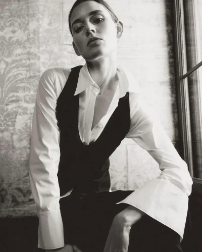 Monochrome portrait of model Vivienne Rohner wearing a white shirt and black vest for Massimo Dutti S/S Venetian Veil 2024