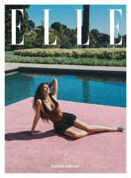 Dakota Johnson posing by a swimming pool in a brown top and black shorts for Elle Brasil September 2025