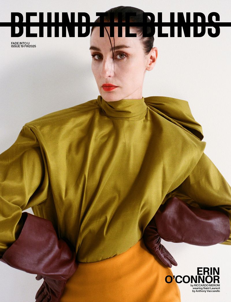 Magazine cover featuring a woman with orange lipstick, wearing a gold top and brown gloves, against a white background. 