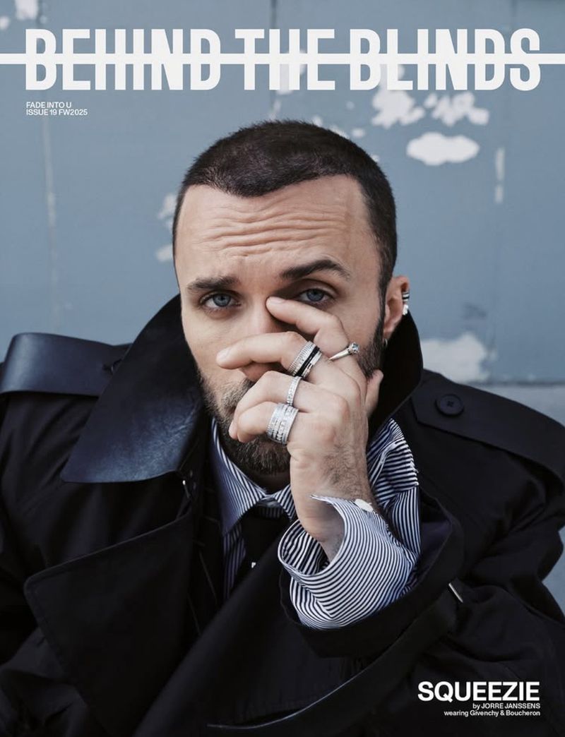 Portrait of Squeezie wearing a black coat and multiple silver rings for Behind the Blinds Fall/Winter 2025.
