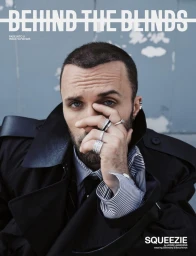 Portrait of Squeezie wearing a black coat and multiple silver rings for Behind the Blinds Fall/Winter 2025.