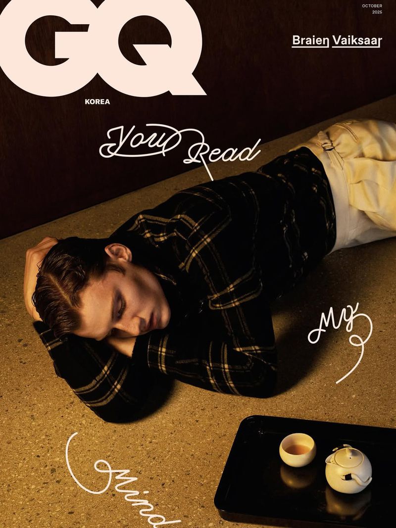 GQ Korea magazine cover featuring a man lying on the floor next to a tea set in a low-key, dark indoor setting with mood lighting.