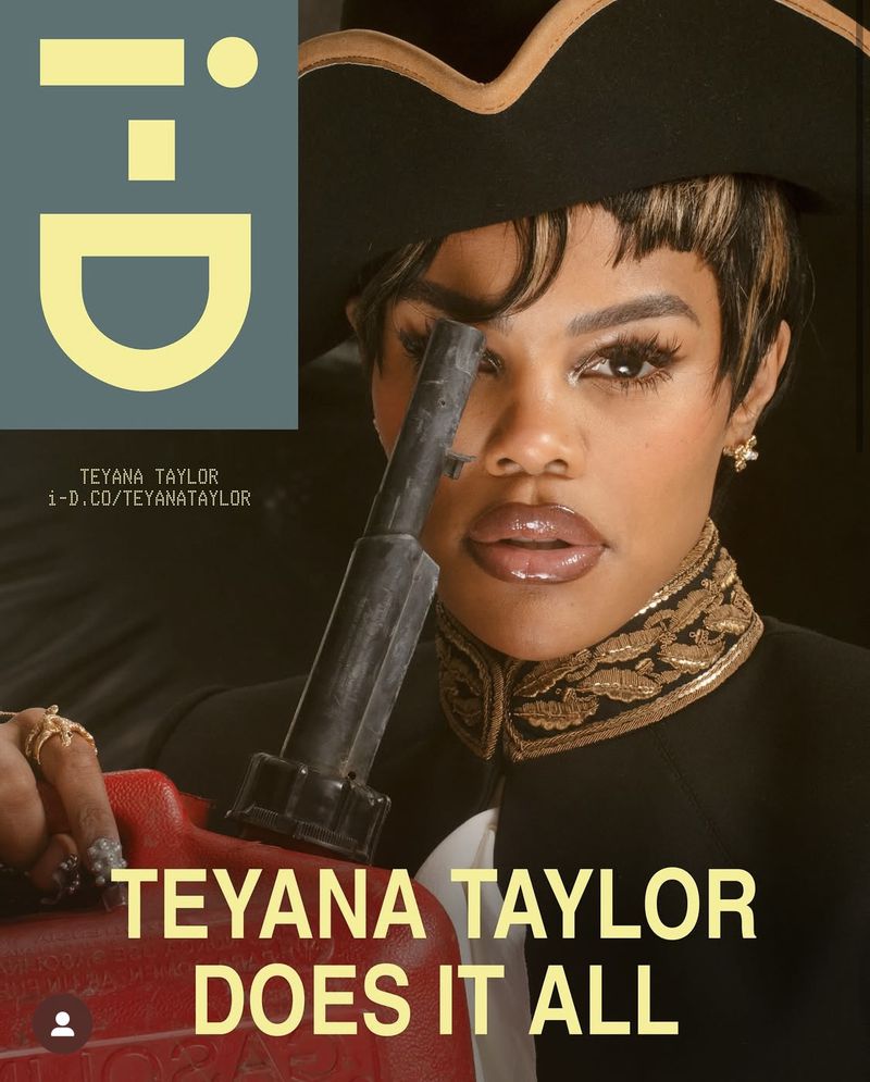 Teyana Taylor poses in a fashion-forward shot for i-D, showcasing a black hat, ornate gold-trimmed jacket, and holding a red gas can.