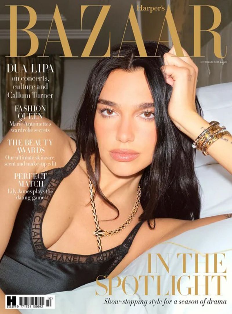 Harper's Bazaar magazine cover featuring Dua Lipa in black lingerie with a gold necklace, posing on a white pillow. Close-up studio shot.