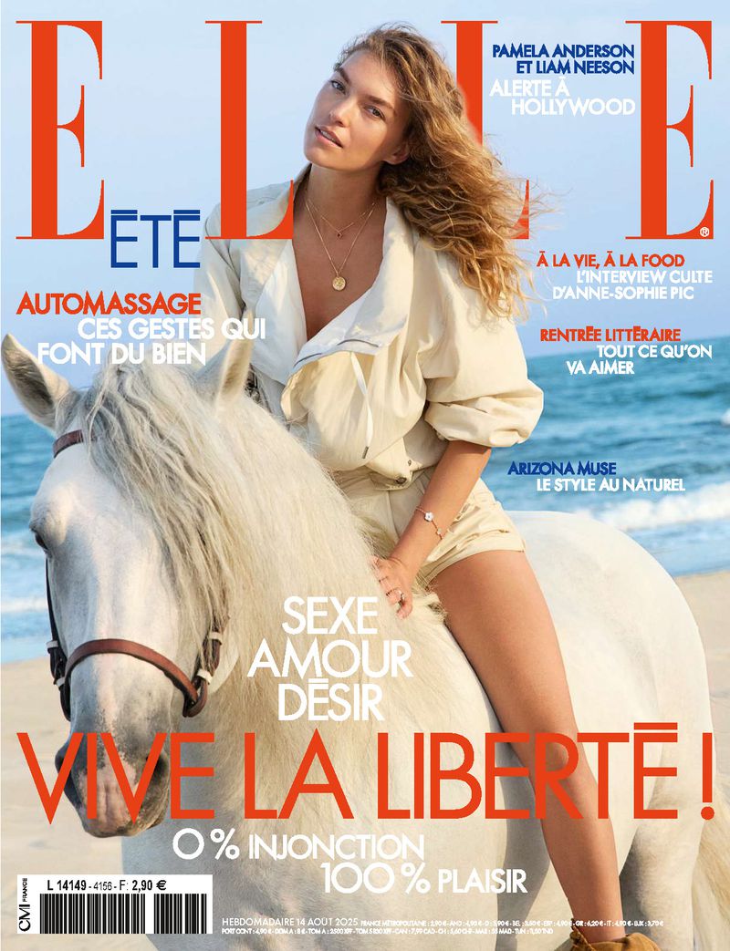 ELLE magazine cover featuring a woman in a tan outfit riding a white horse on the beach. The magazine title is in large red letters.