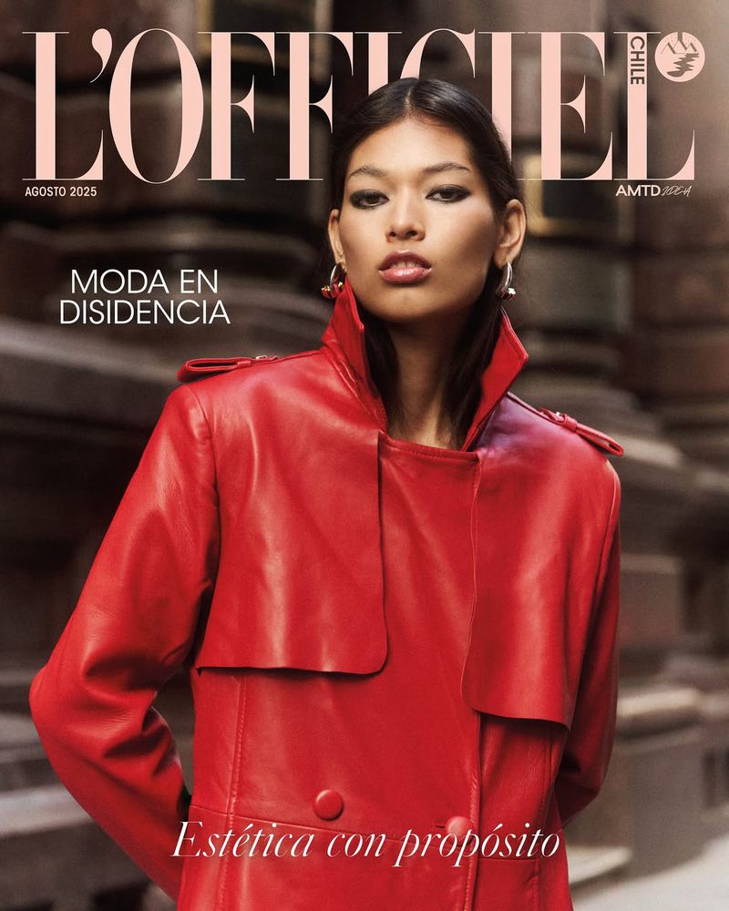 Fashion magazine cover featuring an Asian woman with red leather trench coat, posing in front of blurred architectural background.