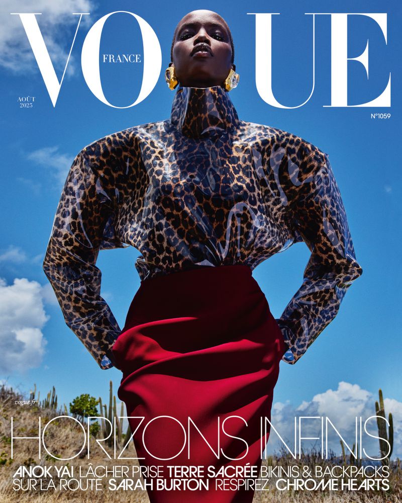 Vogue France magazine cover featuring a Black fashion model in a leopard-print top and red skirt against a vibrant blue sky backdrop.