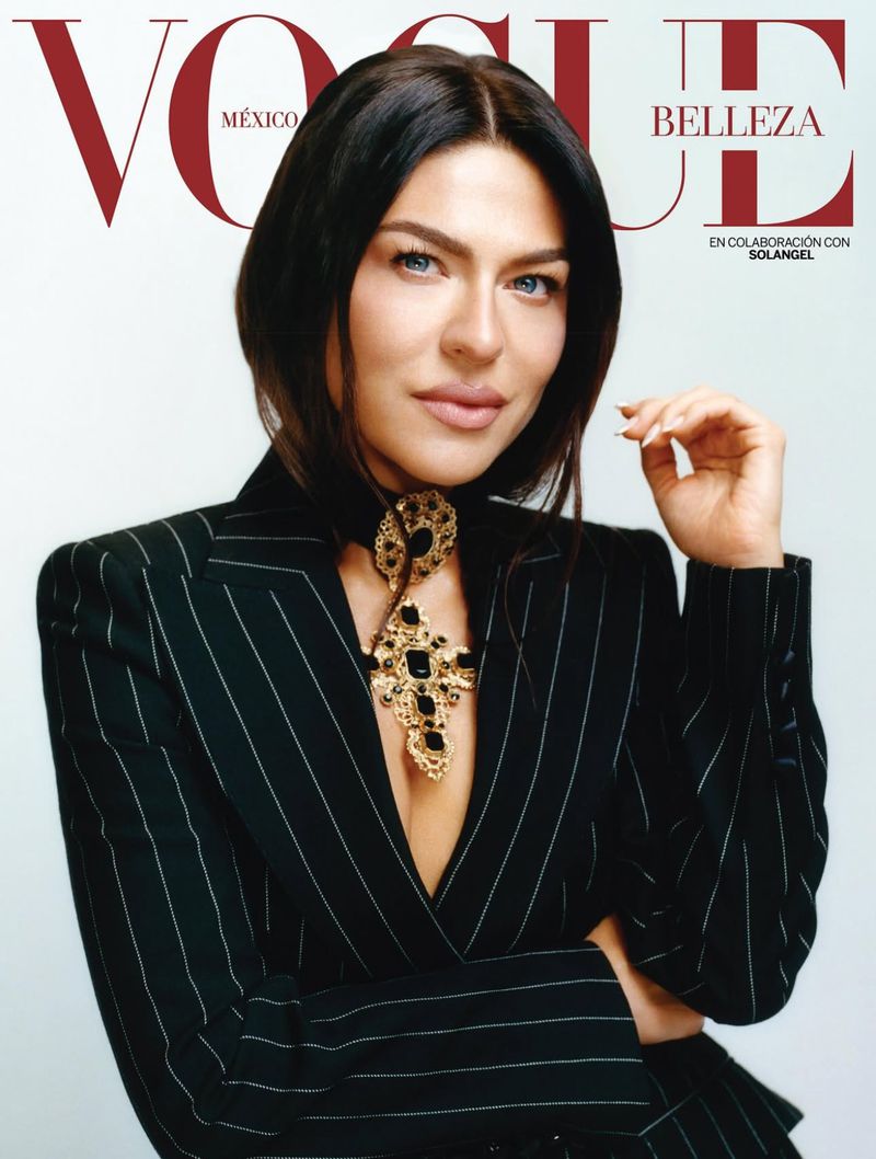Vogue Mexico cover featuring a woman with short dark hair, wearing a black pinstripe blazer and a gold necklace with a cross pendant.