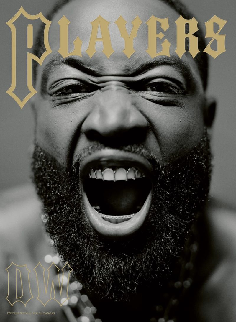 Monochrome studio shot of a man with a beard shouting at the camera, displaying his gold teeth, with magazine type overlayed.
