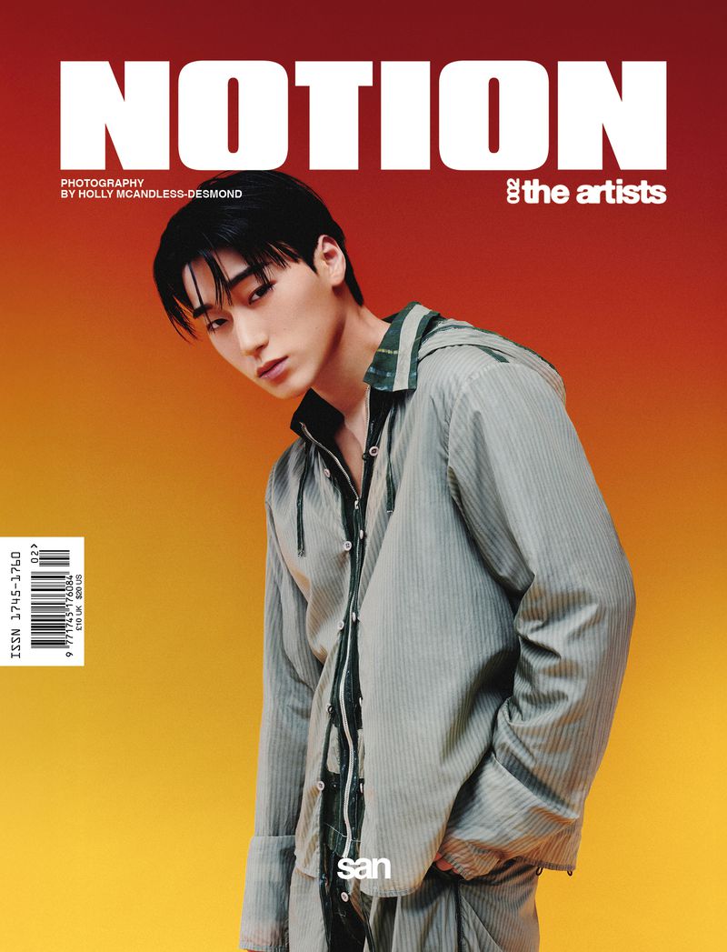 Magazine cover featuring a young Asian man in a striped hooded shirt with a relaxed pose, against a gradient orange background.