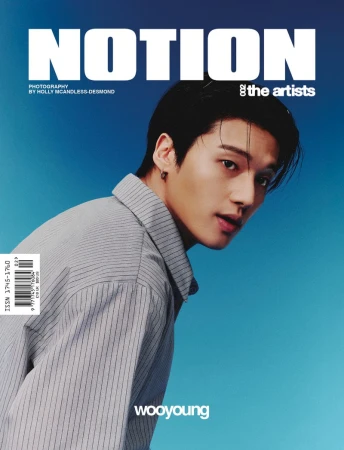 Magazine cover featuring an Asian male model with dark hair wearing a striped shirt, posing against a blue background with white text.