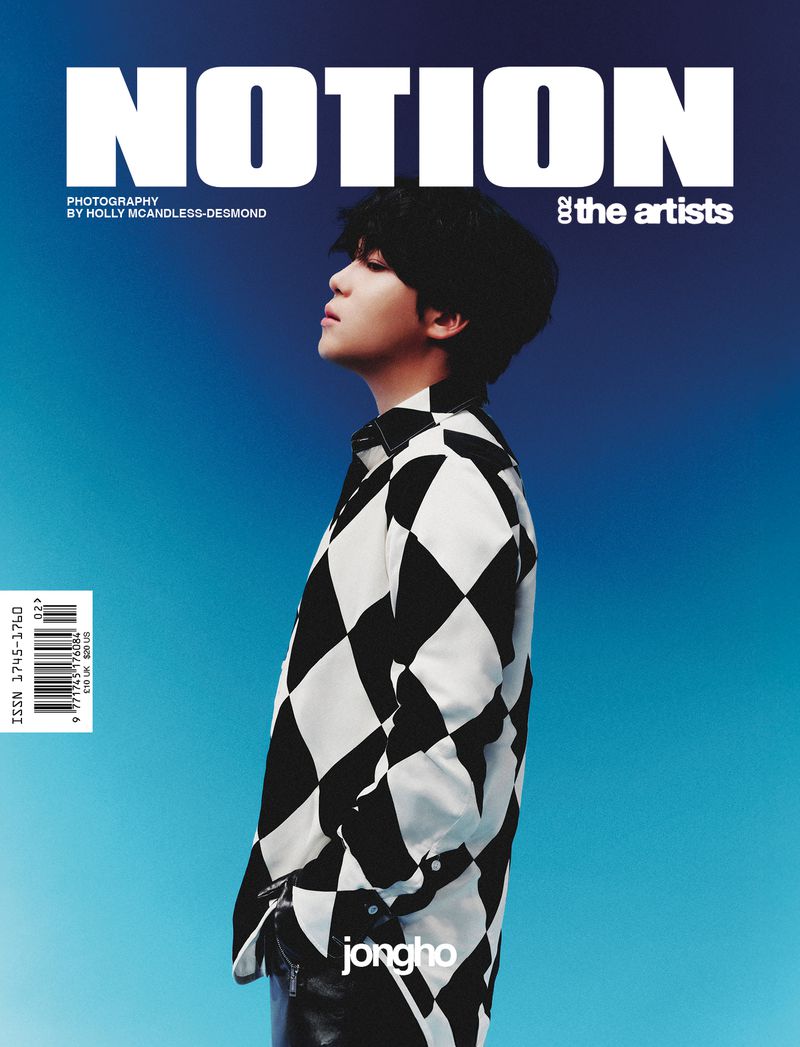 Magazine cover featuring a young adult with black hair in a black and white diamond patterned shirt, against a gradient blue background.