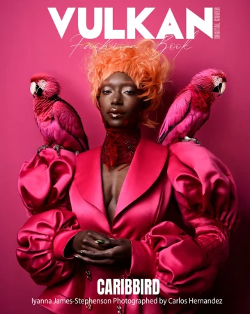 Black woman wearing a magenta blazer with two pink parrots perched on her shoulders against a matching pink background