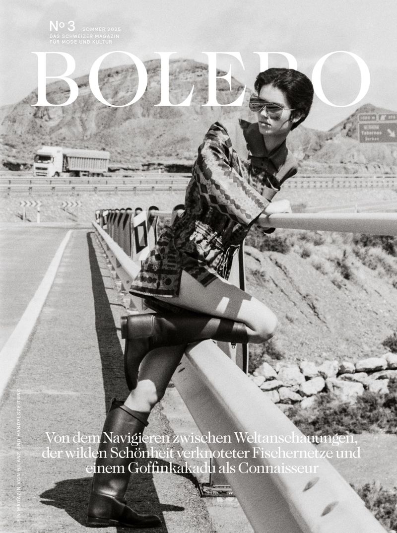 Bolero magazine cover featuring a woman posing on a bridge with a mountainous background in black and white photography.