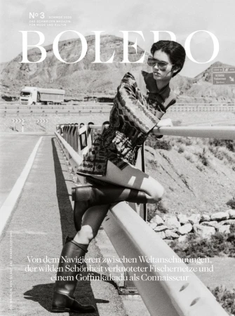 Bolero magazine cover featuring a woman posing on a bridge with a mountainous background in black and white photography.