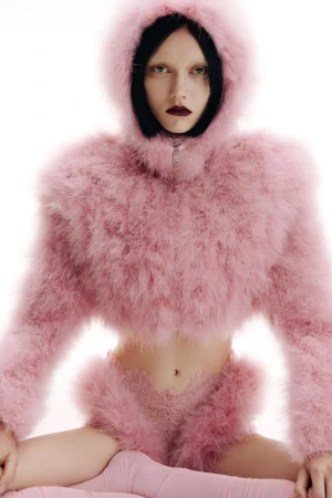 Model wearing a fuzzy pink hooded jacket and matching bottoms against a white background for David Koma