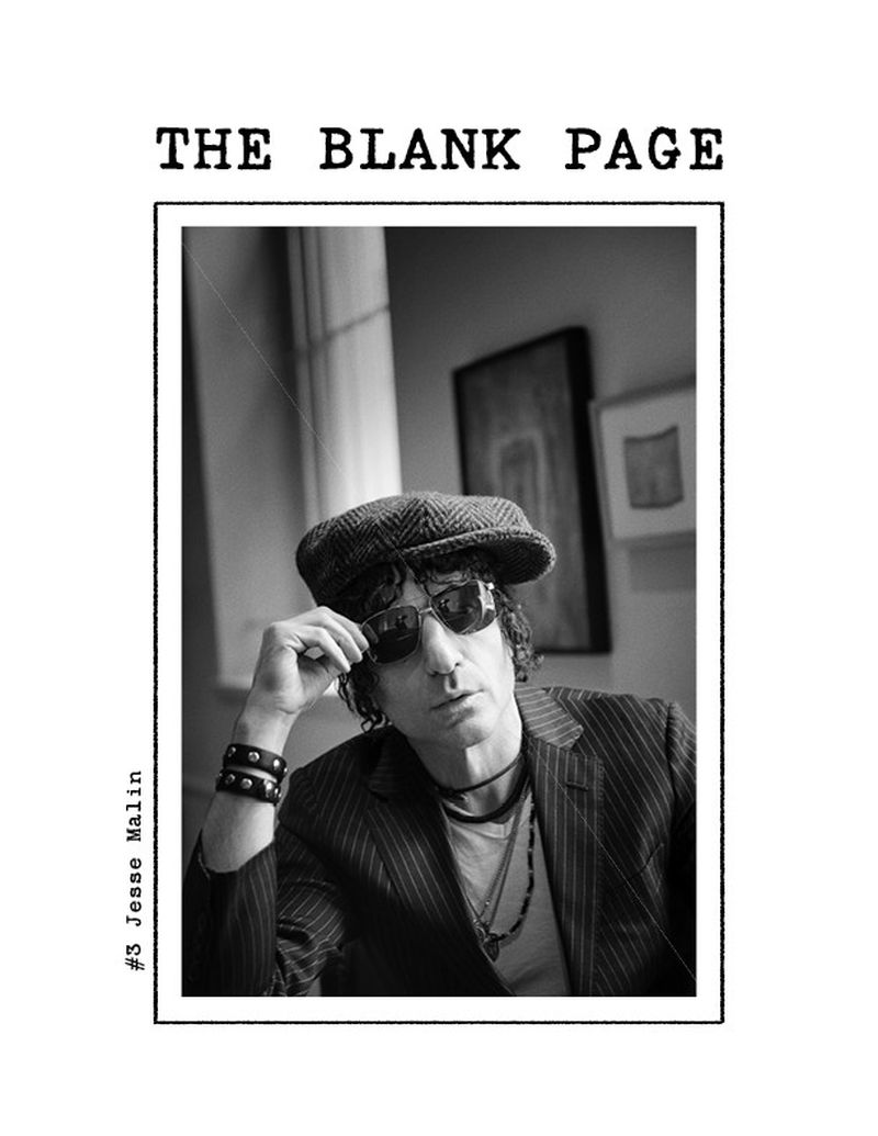 Black-and-white portrait of musician Jesse Malin wearing sunglasses and a cap, in a frame reminiscent of a magazine cover.