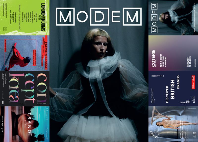 Fashion editorial cover featuring a woman in a black dress and white tulle collar and skirt, against magazine pages and shadowed backdrop.