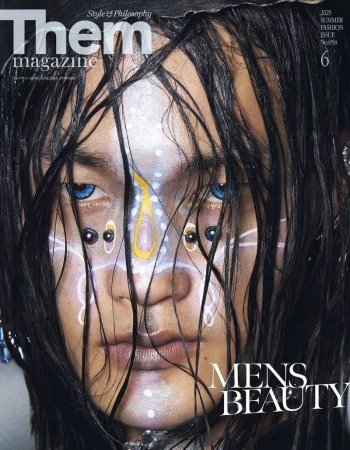 Magazine cover featuring a close-up portrait of a person with wet dark hair, blue eyes, facial piercings, and face paint in a beauty context.