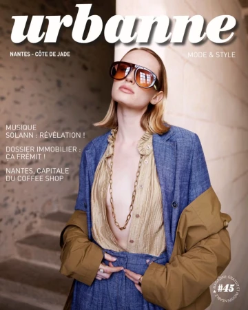 Magazine cover featuring a woman with retro sunglasses, a blue jacket, and a gold necklace, promoting fashion and style, plus local news.