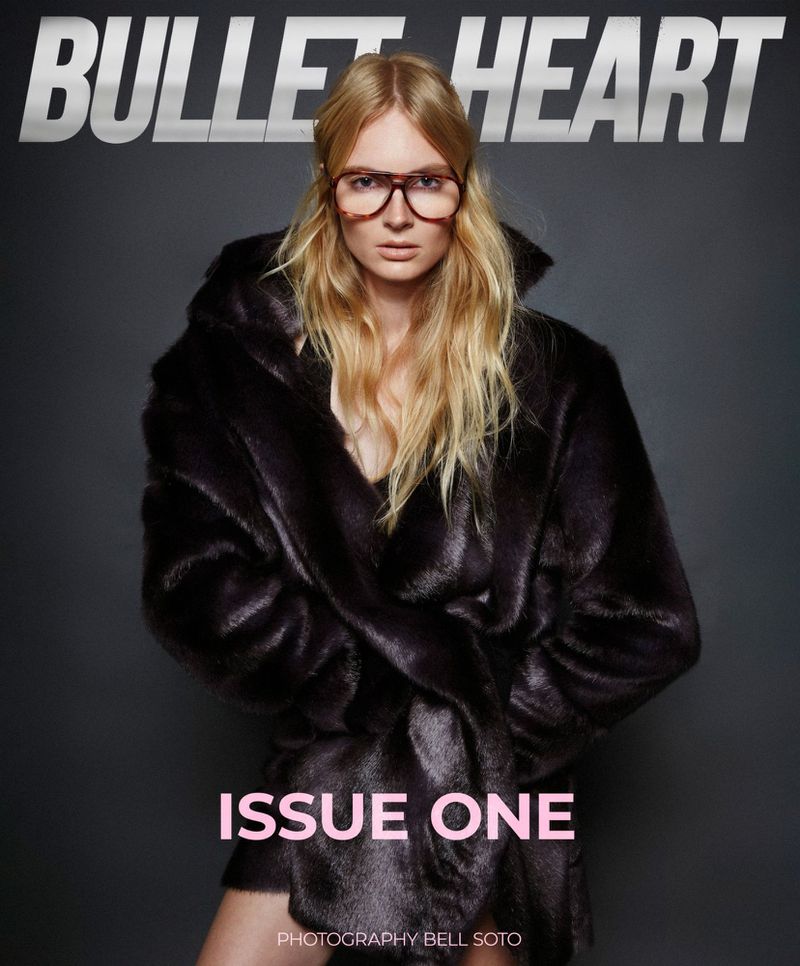 Blonde woman in oversized glasses and a dark fur coat is featured on the Bullet Heart magazine cover with "Issue One" text.