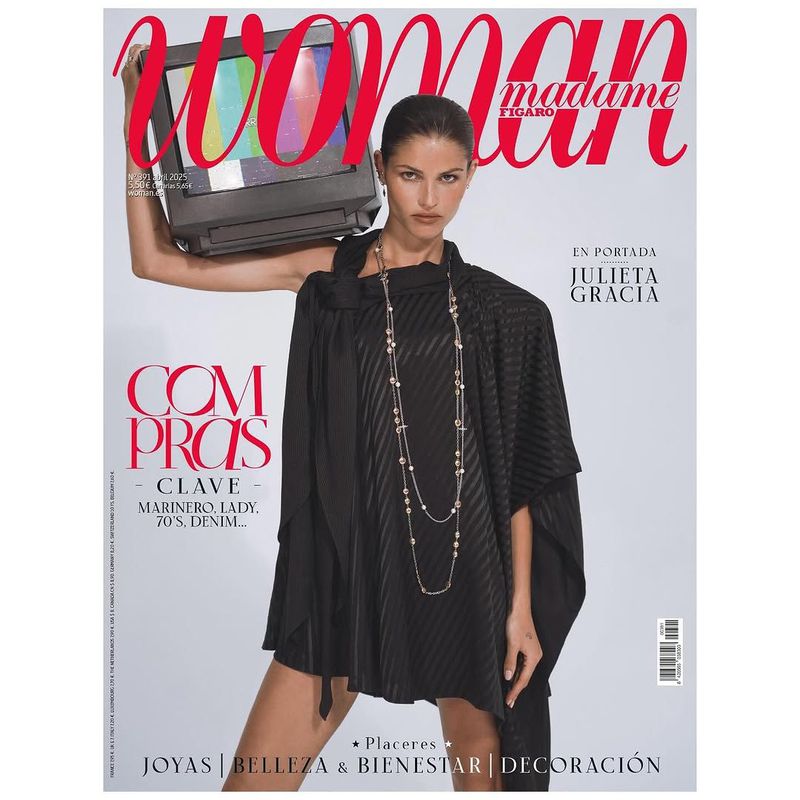 Magazine cover featuring a woman in a black dress holding a television with color bars on her shoulder, set against a gradient gray background.
