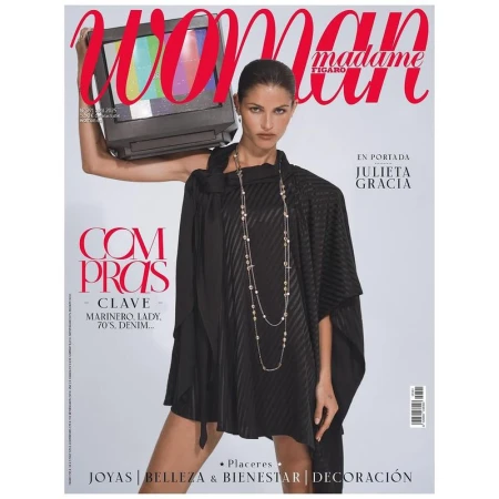 Magazine cover featuring a woman in a black dress holding a television with color bars on her shoulder, set against a gradient gray background.
