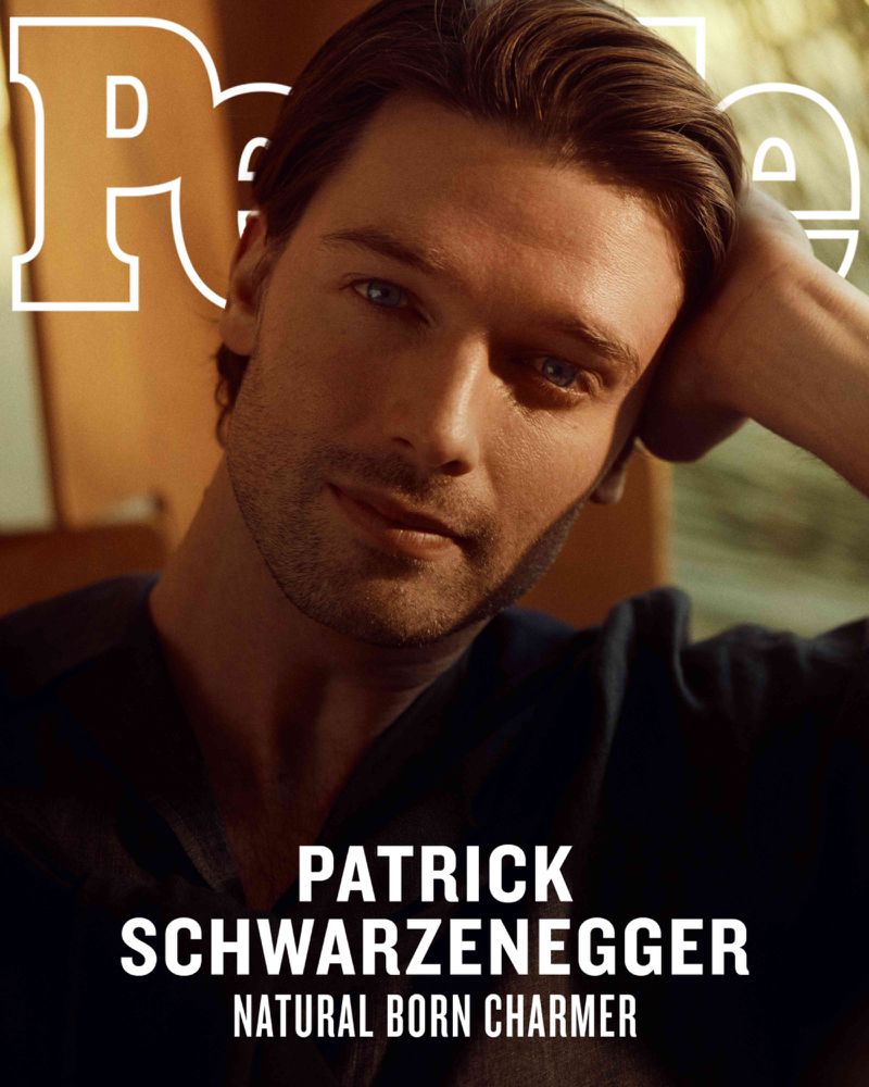 Portrait of Patrick Schwarzenegger on a magazine cover. He has dark hair and blue eyes, wearing a dark shirt. The magazine name is PEOPLE.