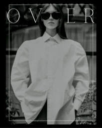Model in dark sunglasses wearing a white oversized shirt against an outdoor backdrop for OVER series by Stencer Saintelange