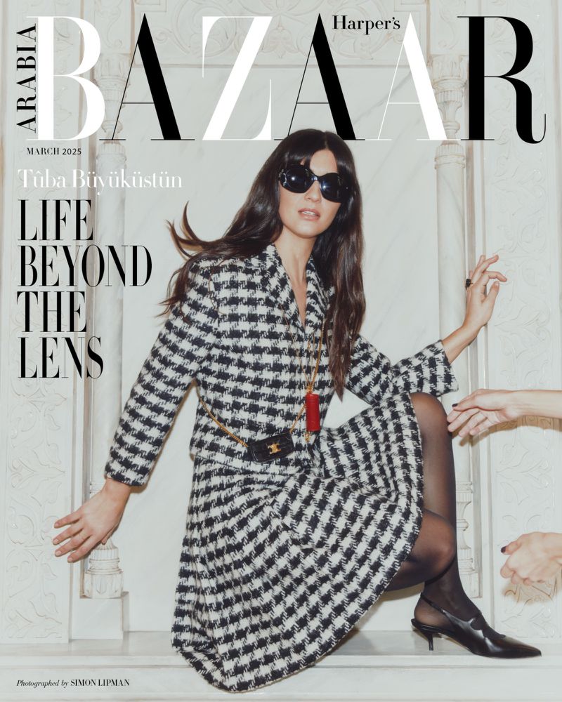 Harper's Bazaar Arabia March 2025 cover featuring Tuba Büyüküstün in a patterned skirt suit with sunglasses, styled by Simon Lipman.