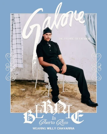 A man sits on a white chair wearing black clothing in a fashion editorial, presented with Galore magazine logo and type overlay.
